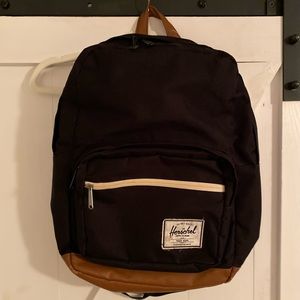 Black Herschel backpack. Laptop slot and 2 small pockets on front